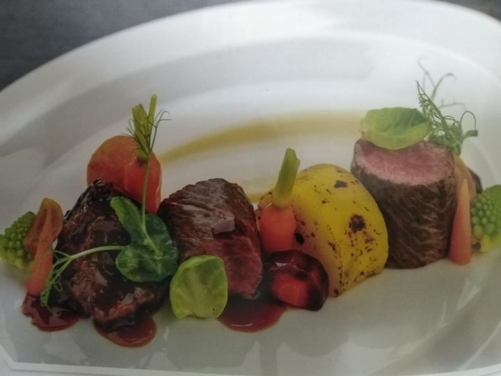 Slow braised beef cheek served with coconut parsnip puree and sauteed vegetable and mint jue