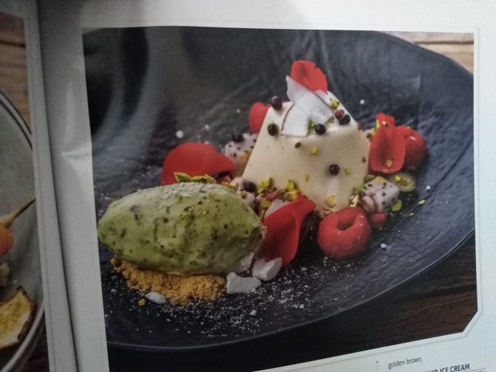 Coconut panna cotta with meringue crumble fresh berries and coconut pistachio ice cream